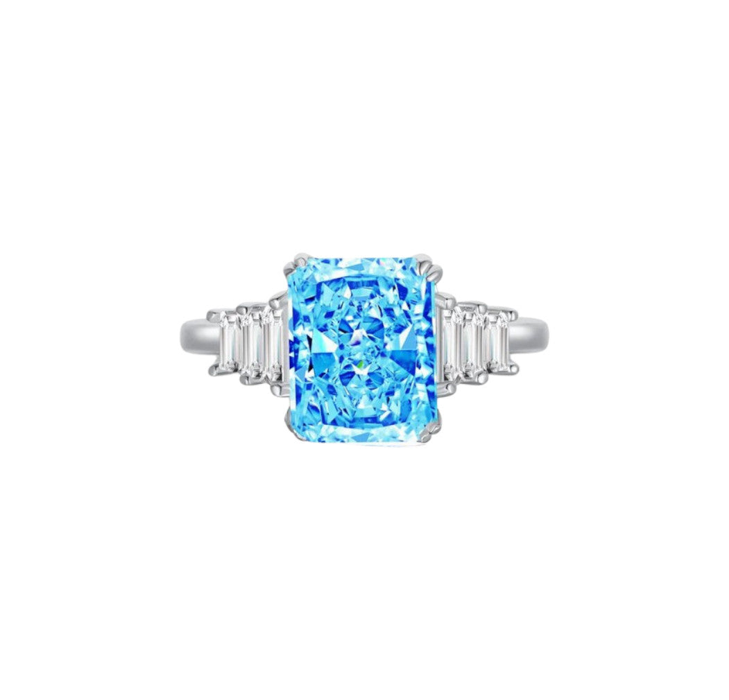 Bague réglable en acier inoxydable avec cristal bleu et zircons blancs. Élégante, brillante et résistante à l'eau. Un bijou à la coupe radiante.