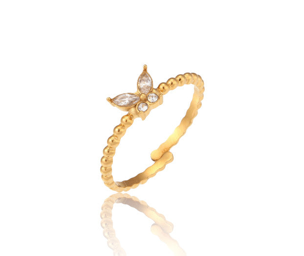 Bague Flora avec papillon en zircon vert ou blanc. Acier doré 18K, ajustable et waterproof, pour un style féminin et lumineux au quotidien.