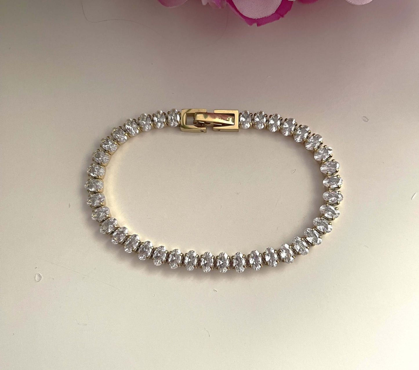 Découvrez l'élégance raffinée du bracelet tennis Chiara , sublimé par ses magnifiques pierres de zircons de coupe ovale. Ce bijou en acier inoxydable de couleur doré ajoute une touche de chic incomparable à votre style.